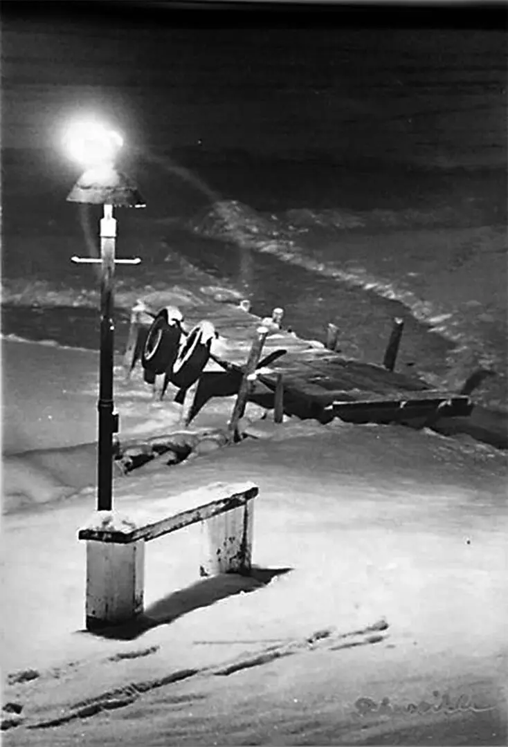 A black and white photo of an airplane landing on the ground.