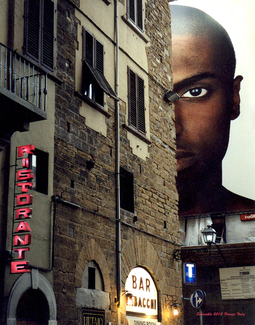 A large poster of a man 's face on the side of a building.